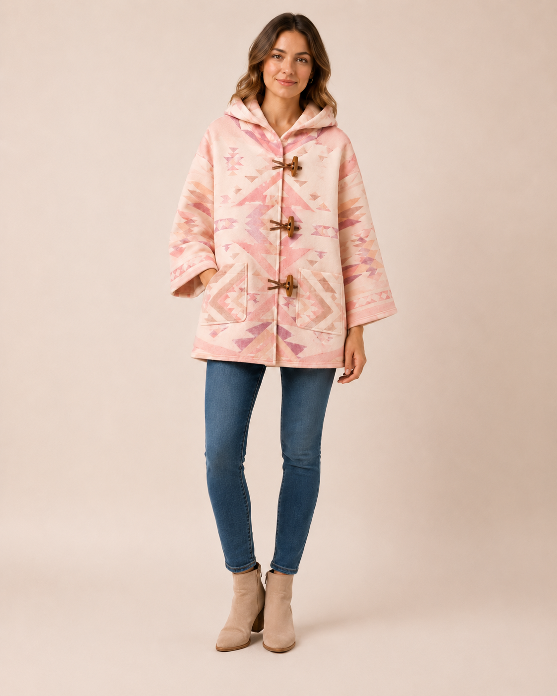 Model wearing the PinkyCoco Blush Desert Geo women's wool blend artistic hooded cape, front view