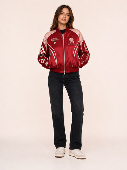 Model wearing the PinkyCoco Cherry Circuit women's satin racing jacket, front view