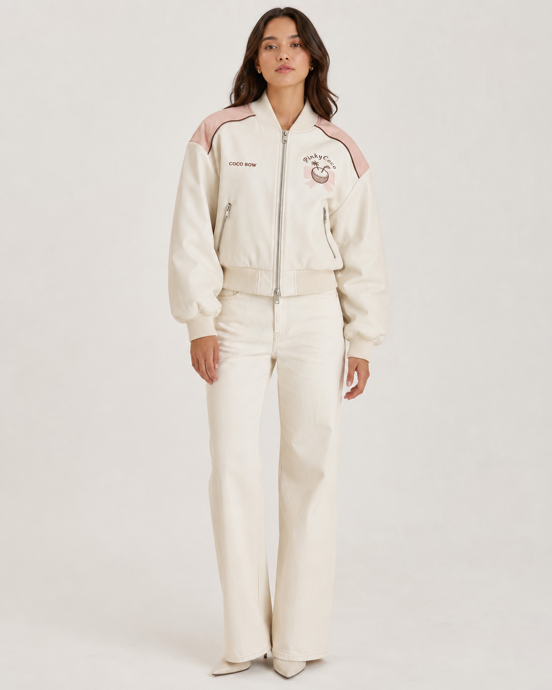 Model wearing PinkyCoco Coco Bow Ivory Women's Satin Bomber Jacket, front view