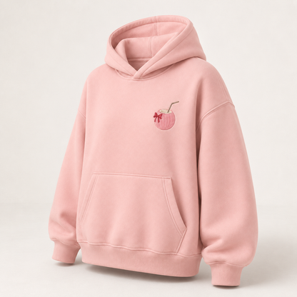 Three-quarter view of the PinkyCoco Blush Ribbon Sunset women's hoodie