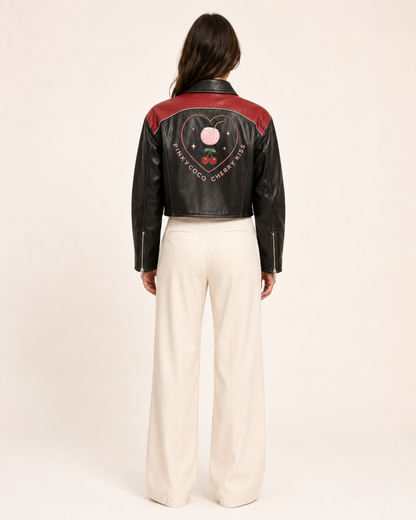 Model wearing PinkyCoco Cherry Kiss Cropped Women's Leather Fashion Jacket, three-quarter view