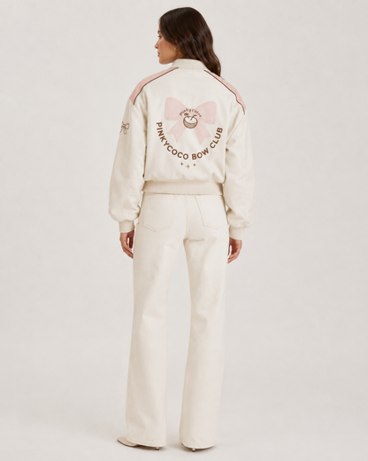 Model wearing PinkyCoco Coco Bow Ivory Women's Satin Bomber Jacket, three-quarter view