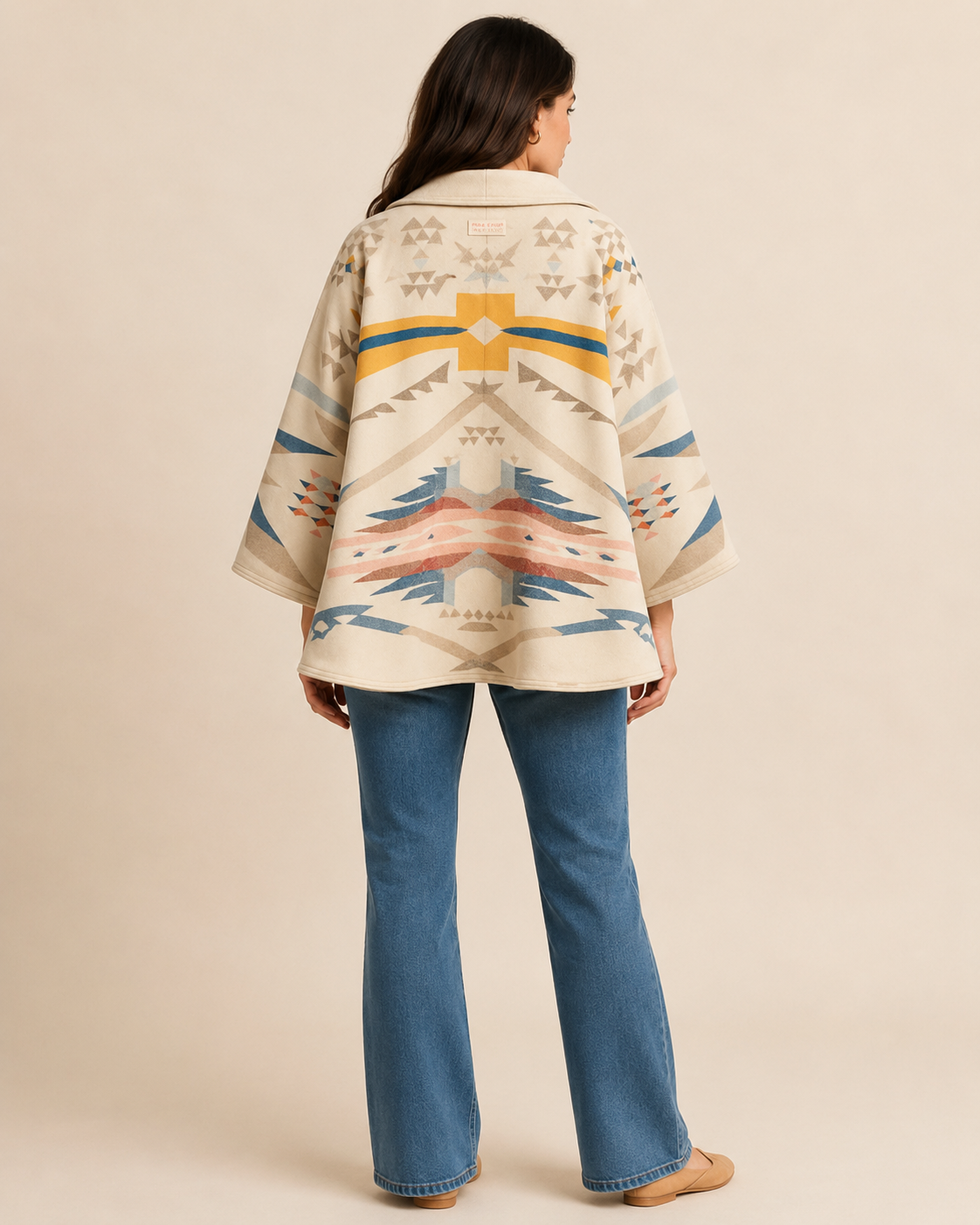 Three-quarter model view of the PinkyCoco Desert Bloom Geo women's wool blend artistic hooded cape