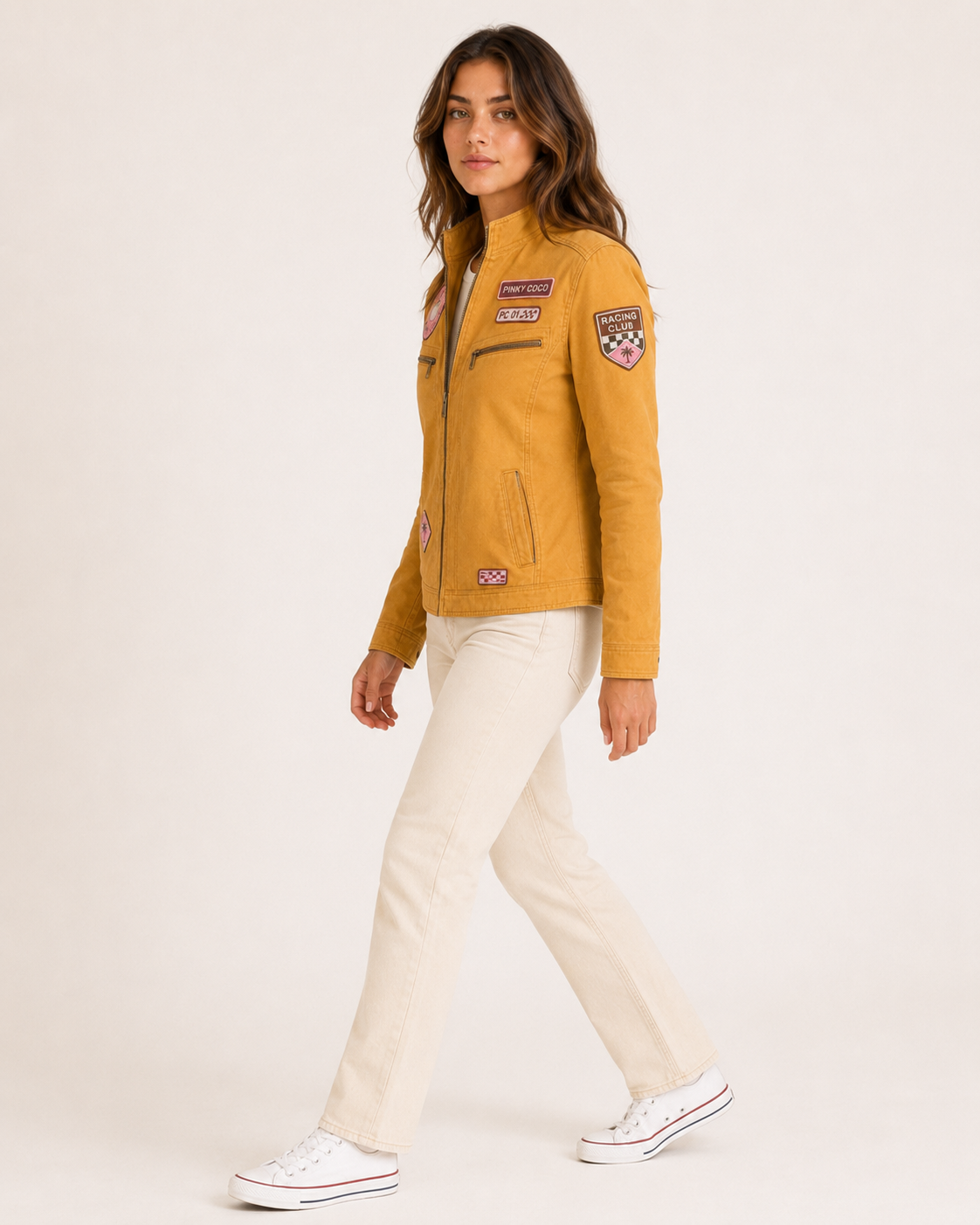Model wearing the PinkyCoco Mustard Patch women's racing jacket, three-quarter view