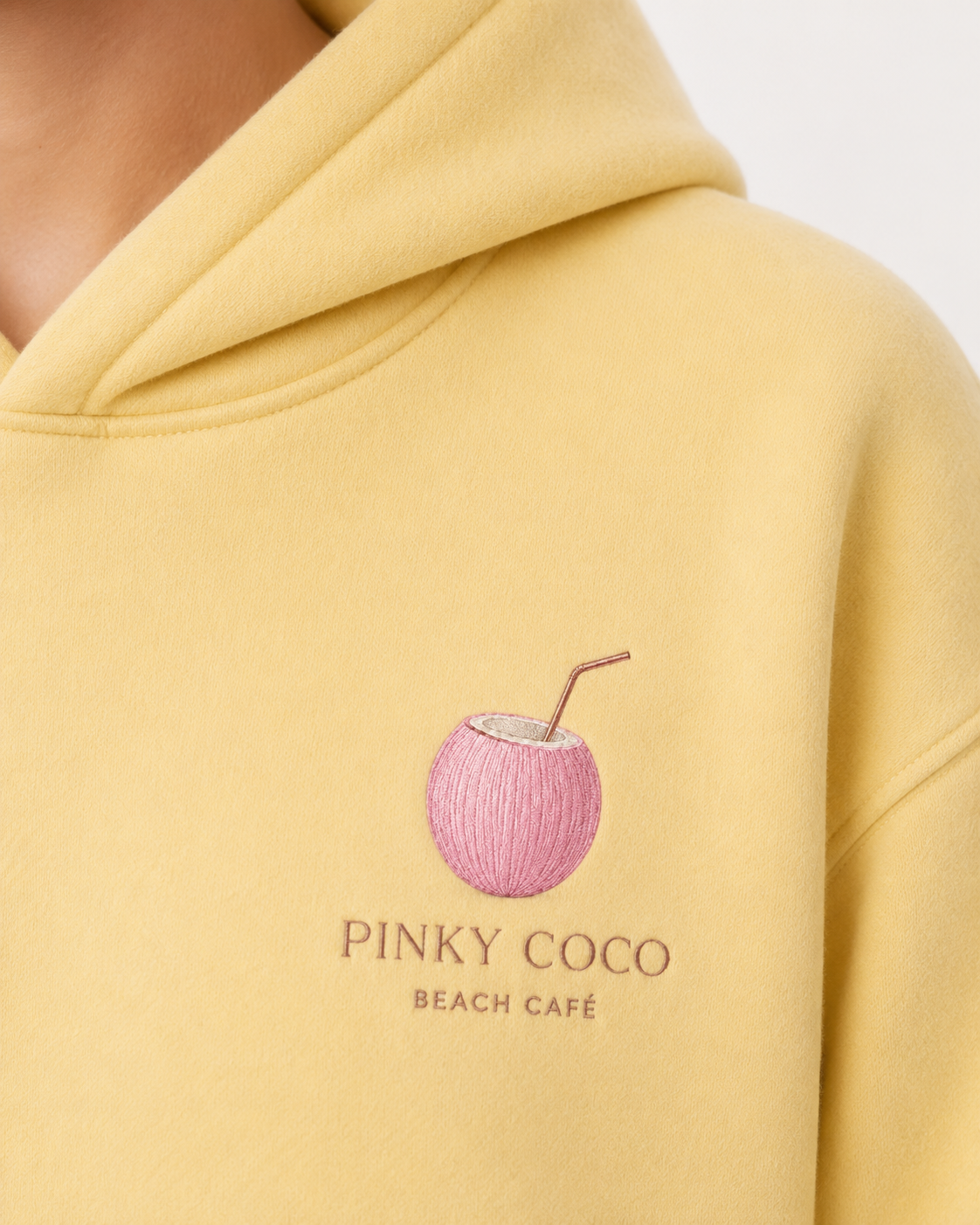 Model showing the back of the PinkyCoco Beach Cafe hoodie