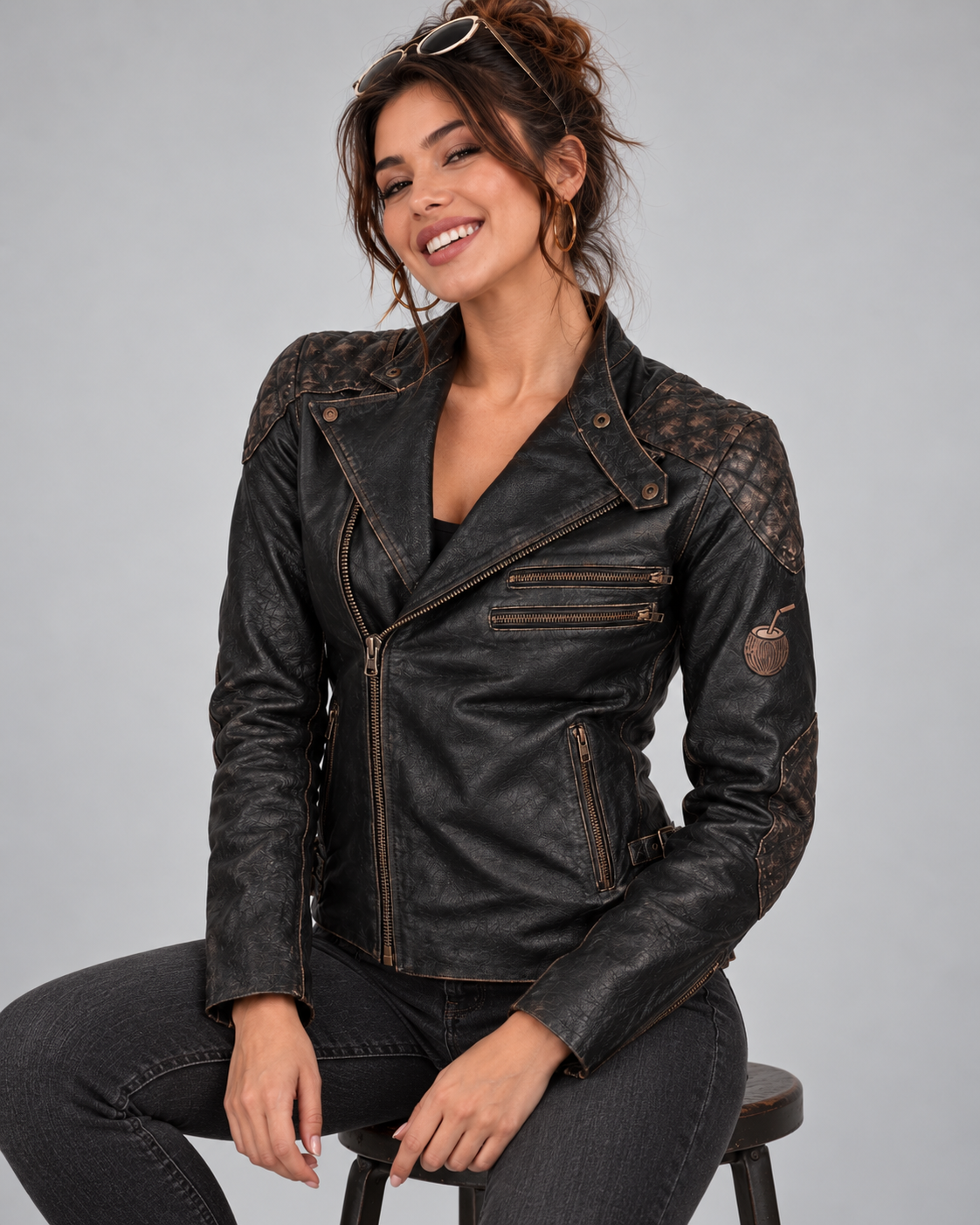PinkyCoco Skull & Bones women's black leather jacket seated lifestyle view